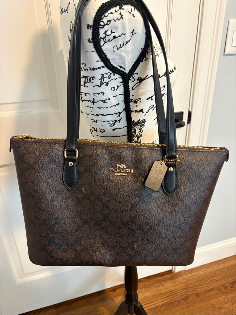 Coach Brown Signature Long ARND Canvas Tote with Black Leather Handles.